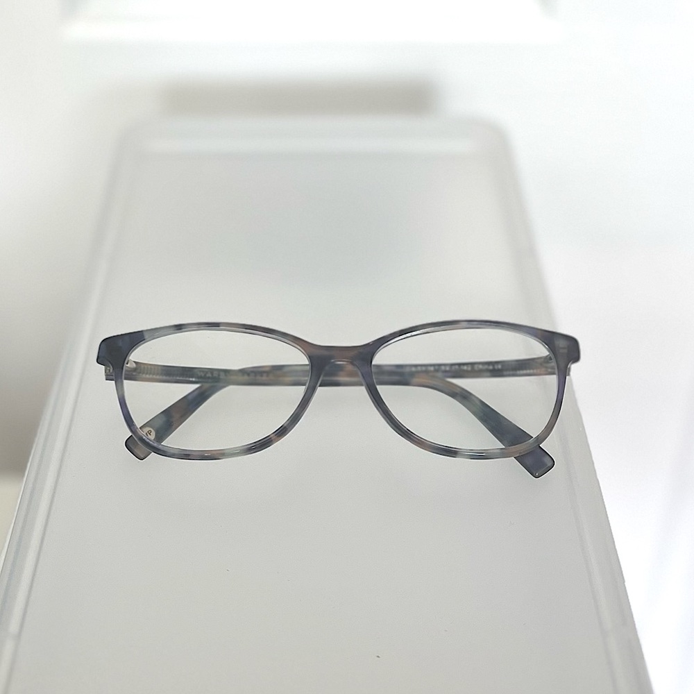 Warby Parker purple tortoise shell glass frames.